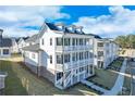 Charming white three-story home with spacious porches, situated in a lovely neighborhood at 1264 Six Sisters St, Dacula, GA 30019