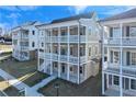 Beautiful three-story home with double-decker balconies and a landscaped yard at 1274 Six Sisters St, Dacula, GA 30019