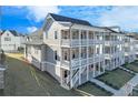 Stunning three-story home with double-decker balconies and a landscaped yard at 1274 Six Sisters St, Dacula, GA 30019