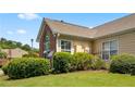 Brick and tan home exterior with satellite dish and manicured lawn at 2191 Rockbridge Rd # 1601, Stone Mountain, GA 30087