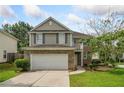 Two-story home with attached garage and manicured lawn at 1187 Andrews Dr, Lithia Springs, GA 30122