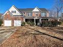 Two-story brick home with attached two-car garage and porch at 1301 Crosswind Pl, Mcdonough, GA 30252