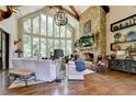 Spacious living room features a stone fireplace, hardwood floors, and abundant natural light at 962 Chattooga Trce, Suwanee, GA 30024