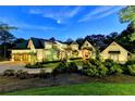 Luxury home exterior at dusk with landscaping and circular driveway at 962 Chattooga Trce, Suwanee, GA 30024