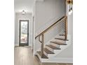 Modern staircase with wood steps and cable railing at 1420 Coretta Bend, Atlanta, GA 30318