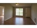 Living room with wood floors and large window at 9451 Sleepy Hollow Ln, Jonesboro, GA 30238