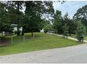 Ranch style home with a large grassy yard and driveway at 2023 Lee Dr, Austell, GA 30168