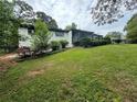 Mid-century modern ranch house with updated exterior and deck at 2023 Lee Dr, Austell, GA 30168