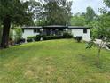 Mid-century modern ranch house featuring a freshly painted exterior and deck at 2023 Lee Dr, Austell, GA 30168