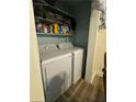 Laundry closet with washer and dryer and extra shelving at 286 Pauladean Se Cir, Marietta, GA 30067