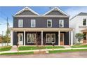 Two-story duplex with dark siding, covered porches, and well-manicured lawns at 597 Federal Se Ter, Atlanta, GA 30315