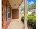 Brick front porch with white columns and gray shutters at 111 Iverson Pl, Temple, GA 30179