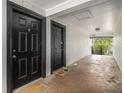 Shared entryway with two black doors and welcome mats at 3599 Woodbriar Cir # E, Tucker, GA 30084