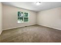 Spacious carpeted bedroom with large window at 101 Dodd St, Fairburn, GA 30213