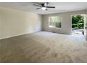 Spacious living room with neutral carpet and view of backyard at 101 Dodd St, Fairburn, GA 30213