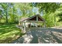 Covered carport with a spacious parking area at 3125 Lakeside Dr, Cumming, GA 30041