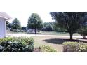 Community view with playground and trees at 221 Bridgemill Ln, Hampton, GA 30228