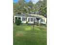 Light green house with black shutters and a grassy lawn at 939 Beecher Sw Ct, Atlanta, GA 30311