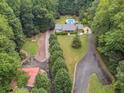 House nestled in wooded lot with a pool and long driveway at 3992 Doc Sams Rd, Cumming, GA 30028
