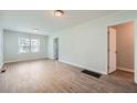 Bright living room featuring wood-look flooring and updated light fixtures at 2666 Blount St, Atlanta, GA 30344