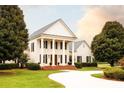 Elegant two-story house with a large circular driveway and mature landscaping at 1875 Highway 142, Covington, GA 30014