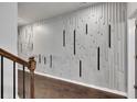 Modern hallway with dark hardwood floors and an accent wall at 5586 Cannonade Ln, Stonecrest, GA 30058