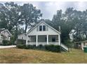 White house with front porch and landscaping at 2203 Hillcrest Ave, Decatur, GA 30032
