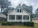 White house with front porch and landscaping at 2203 Hillcrest Ave, Decatur, GA 30032