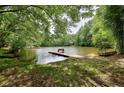 Serene lakefront property with dock and bench, perfect for relaxing by the water at 3660 Juhan Rd, Stone Mountain, GA 30087