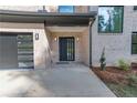 Modern front entrance with black metal door and brick facade at 2861 Tree Top Rd, Dacula, GA 30019