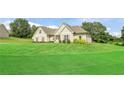 Ranch style home with a large green lawn at 95 Line Dr, Newborn, GA 30056