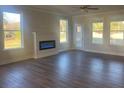 Spacious living room with hardwood floors, fireplace, and plenty of natural light at 2404 Anhinga Dr, Loganville, GA 30052