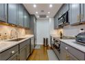 Modern kitchen with gray cabinets, granite countertops, and stainless steel appliances at 145 15Th Ne St # 1012, Atlanta, GA 30309