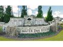 Water Oak Estates community entrance sign with landscaping at 1641 Lacebark Elm Way, Lawrenceville, GA 30045