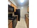 Galley kitchen with granite countertops and black appliances at 2955 Seven Pines Ln # 206, Atlanta, GA 30339