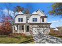 Two-story house with gray siding, stone accents, and a two-car garage at 57 Rockingwood Vw, Dallas, GA 30157