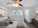 Virtually staged bedroom with a ceiling fan and en suite bathroom at 2653 Tilson Rd, Decatur, GA 30032