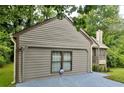 Side view of the house showcasing the garage at 649 Woodcrest Manor Dr, Stone Mountain, GA 30083