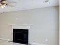 Living room with a classic fireplace and ceiling fan at 649 Woodcrest Manor Dr, Stone Mountain, GA 30083