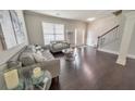 Living room with hardwood floors, gray sofa and love seat, and coffee table at 437 Livingston Pt, Acworth, GA 30102