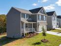 Two-story gray house with a white front door and a nicely landscaped yard at 663 Highgrove Way, Dallas, GA 30157