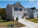 Two-story house with gray siding, two-car garage, and front porch at 675 Highgrove Way, Dallas, GA 30157