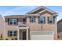 Two-story brick home with a two-car garage and landscaped lawn at 2106 Waycross Ln, Dacula, GA 30019