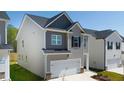 Two-story house with neutral siding, a two-car garage, and a well-maintained lawn at 12000 Conrad Cir, Hampton, GA 30228