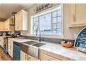 Kitchen with farmhouse sink, granite counters and teal dishwasher at 1107 N Van Wert Rd, Villa Rica, GA 30180