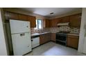 Small kitchen needing updates with wood cabinets and appliances at 2900 Kevin Ln, Jonesboro, GA 30236