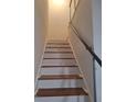 Interior staircase with wood steps and metal railing at 1847 Whitehall Forest Se Ct, Atlanta, GA 30316