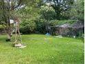 Large backyard with mature trees and a windmill at 126 Irvin St, Jonesboro, GA 30236