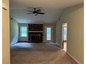 Spacious living room with a brick fireplace and access to a sunroom at 1799 Brandy Woods Se Trl, Conyers, GA 30013
