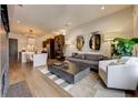 Open concept living room with hardwood floors and a view into the kitchen at 330 Heatherden Ave, Fayetteville, GA 30214